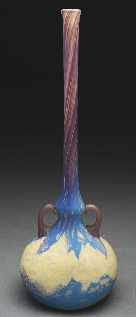 Daum Nancy Handled Deco Vase.: Daum Nancy Art Deco vase has squat bulbous body with long slender neck, flared top rim and applied purple striated glass handles, glass decorated with mottled internal blue and yellow in body with pur