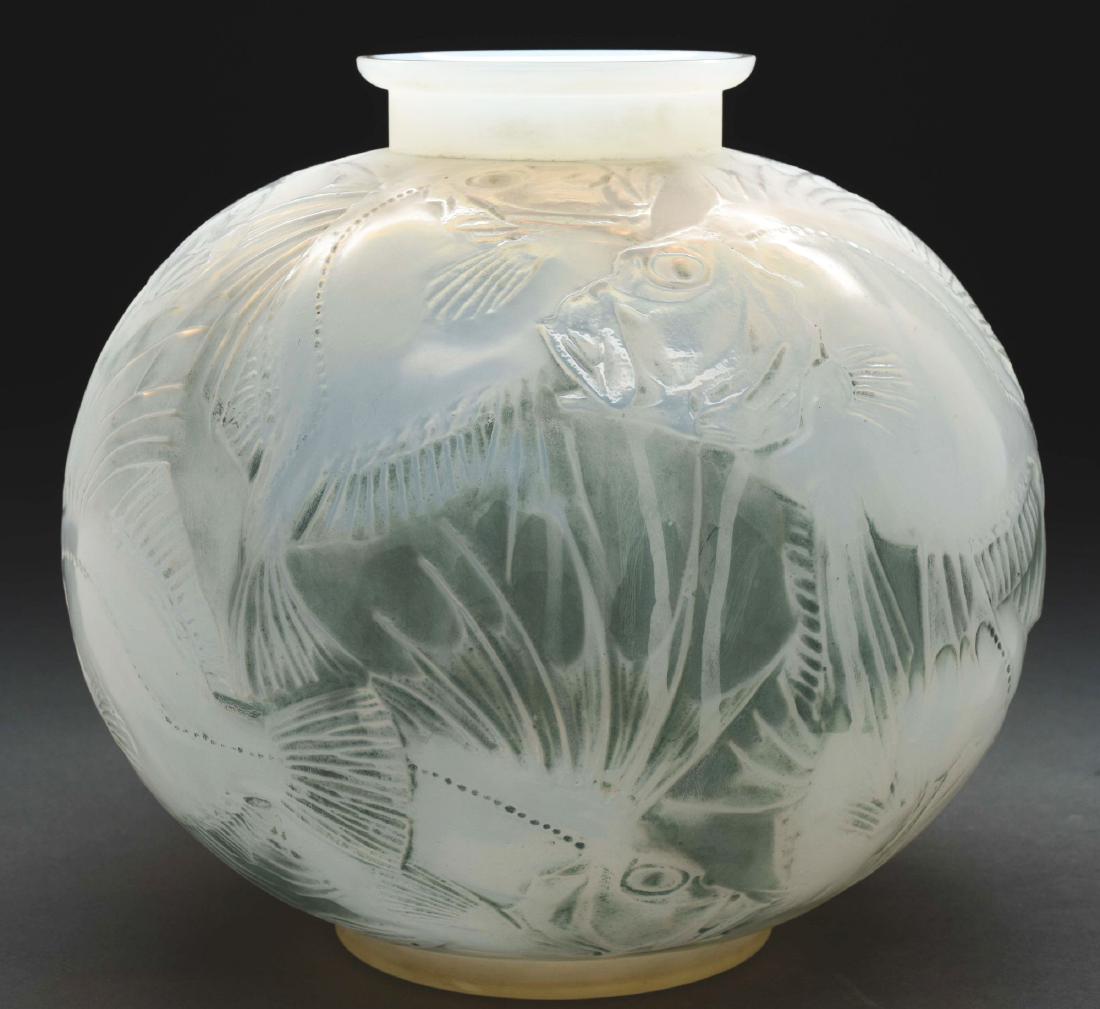 R. Lalique Poissons Vase.: Lalique vase in the Poissons design has a school of fish encircling the body of the vase. The vase is done in opalescent glass and the pattern is highlighted with green patination. Signed on the under