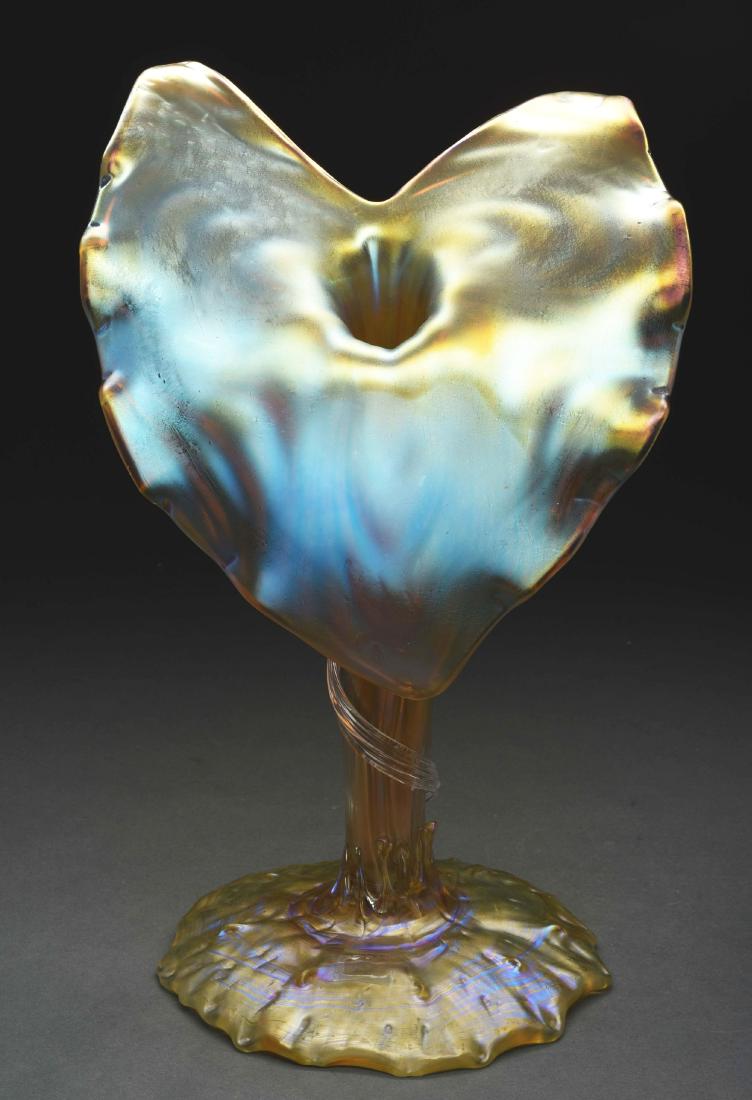 Loetz Flower Form Vase.: Loetz vase has stylized Jack in the Pulpit form with an organic round foot, ribbed stem leading to the jack in the pulpit face. The back of the jack has a raised loop design while the front is smooth.