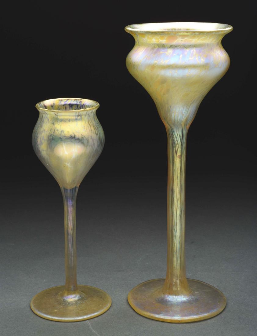 Lot of Two Loetz Goblets.: Lot contains two Loetz Papillon goblet vases. Each has a slender stem, bulbous body and slightly flaring lip. Both are finished with iridescent oil spot decoration that shows purple and blue flashes.