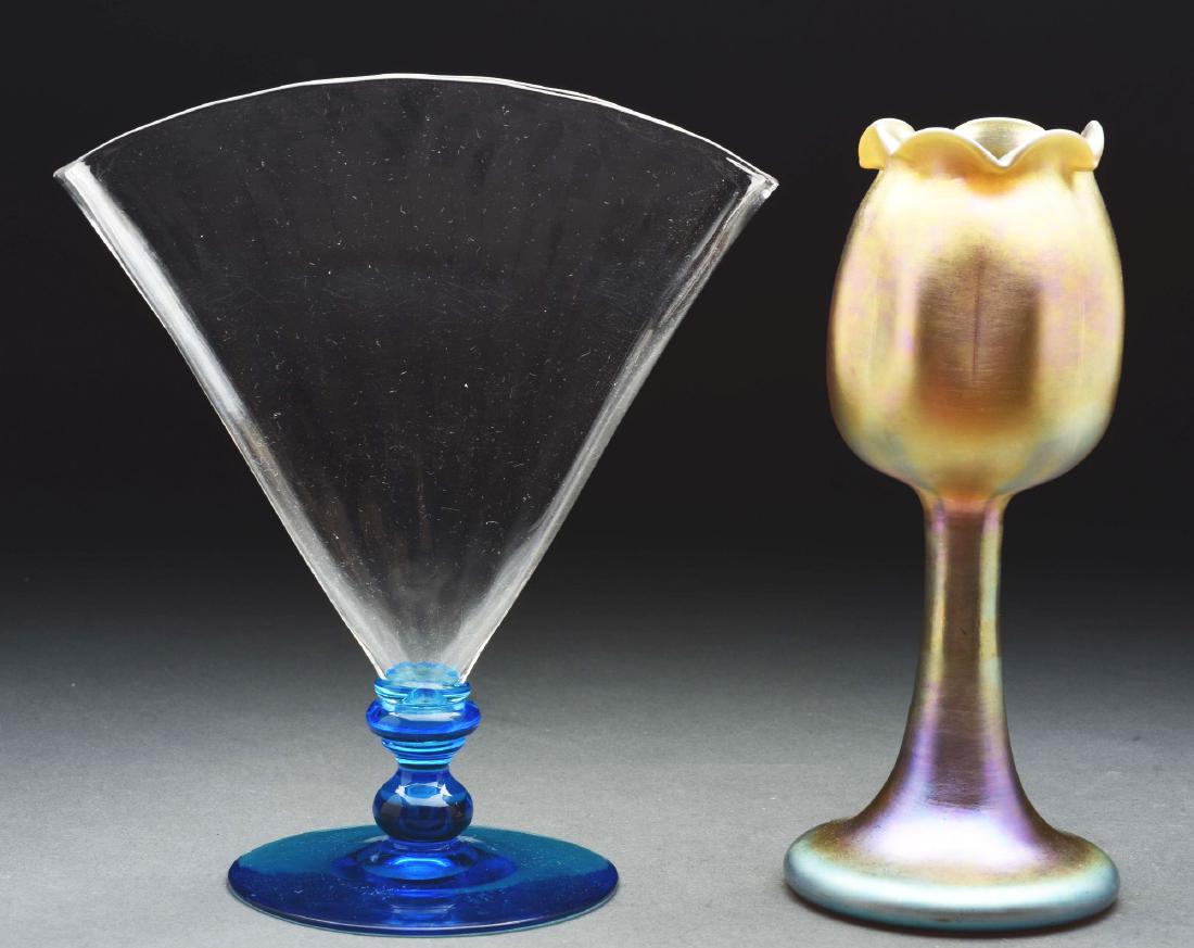 Lot of Two Steuben Vases.: Lot includes 1) Steuben fan vase has vertically ribbed clear glass body resting on a Celeste blue foot and stem. Signed on the polished pontil with acid etched fleur-de-lis logo "Steuben". 2) Gold Aur