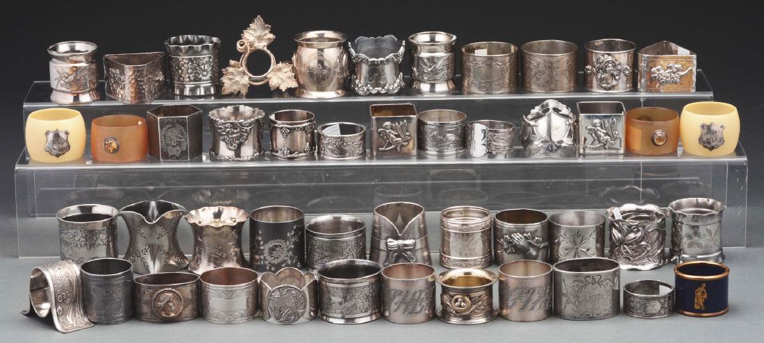 Lot Of Over 50 Silver Plated Antique Napkin Rings.: Many rings are embossed with animals and birds. Five are Bakelite and six are matching with a floral pattern. All show some wear from age and use. Condition: (Very Good - Excellent). Item Dimensions: