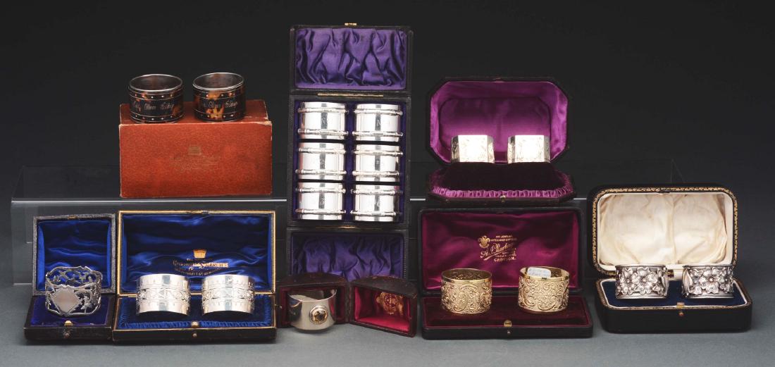 Lot Of 8: Sets Of Boxed Napkin Rings.: Lot includes: a set of two tortoise with gold pique on silver napkin rings marked "Captain Oliver Elchidge 1869" in gold; a set of six silver plate napkin rings from an old cruise ship numbered one th