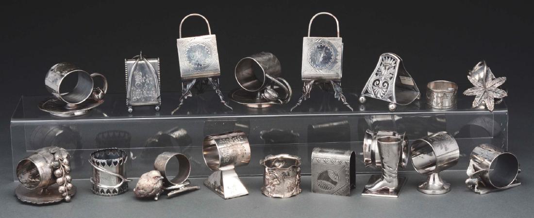 Lot of 17: Silver Plated Napkin Rings.: Lot includes: 15 figural rings and two children's napkin rings. The second child's ring is decorated with Brownies and has unusual wear from age. Condition: Item Dimensions: Largest : 5" x 3".