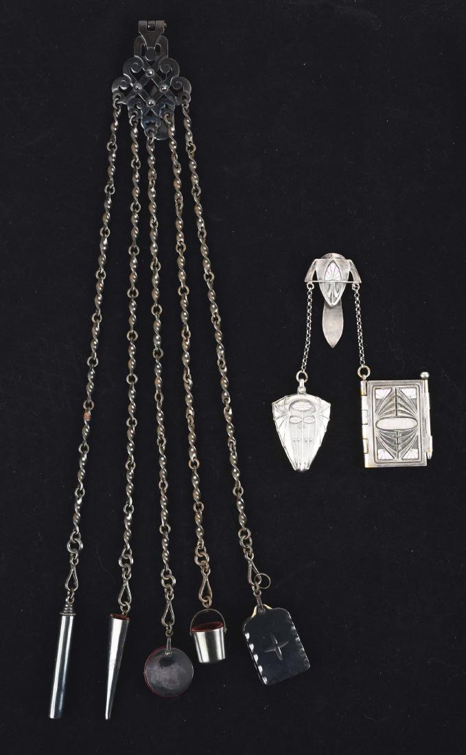 Lot of 2: Antique English Victorian Chatelaines.: The first is a silver plated and enameled Art Nouveau chatelaine with a mirror and booklet with pencil. The second is a black lacquered chatelaine with five accessories, a tablet, thimble holder, pin