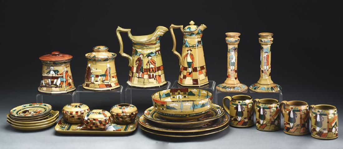 Group of Buffalo Deldare Pottery including examples of: Early 20th century, Buffalo New York. Group includes: Rare six-panel 10-1/2" chocolate pot "Ye Village Street" 1909 backstamp, artist is "E. Dumars", very good condition. Pair of 9" candlestick lamp b