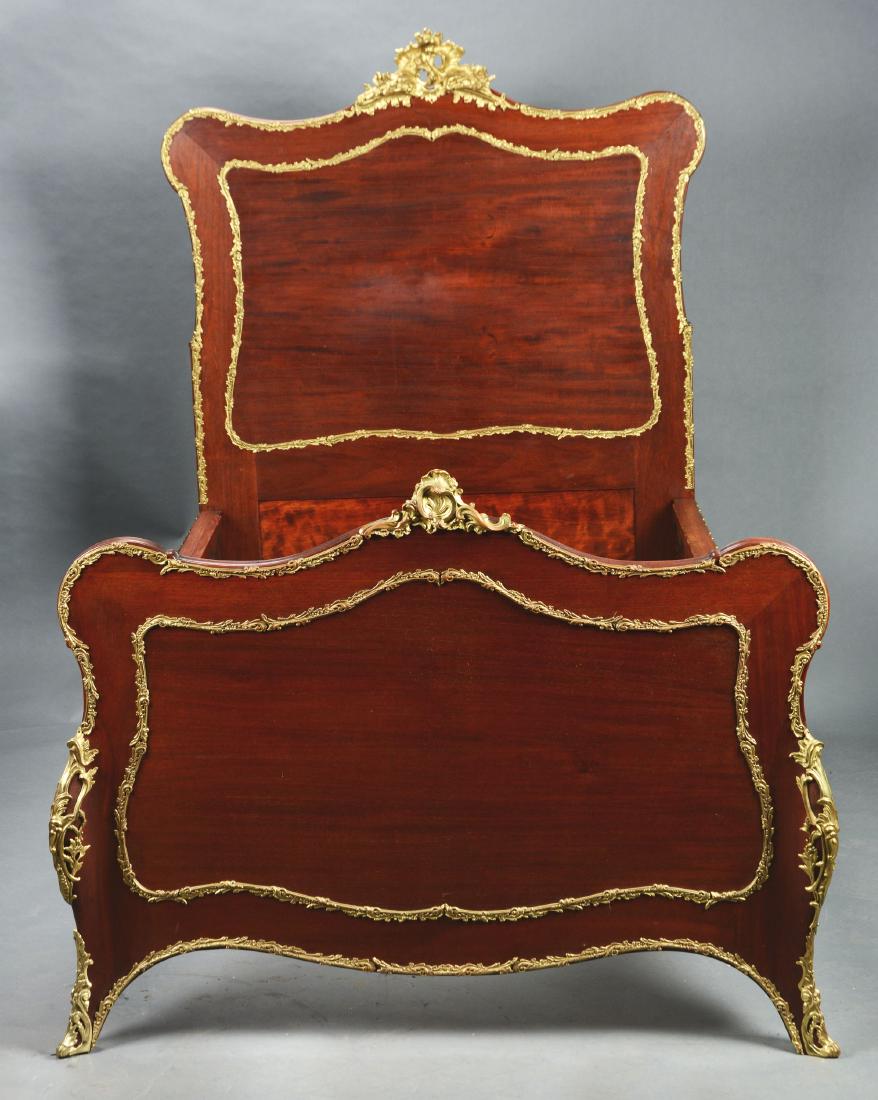 Lot Of 3: Fine Pair Of Mahogany Louis XV Style Beds and: Late 19th century, France. Each bed with a serpentine crest surmounted by cast brass gilt crest. The head board and foot board with molded and cast ormolu foliate trim boarders. The paneled head and f