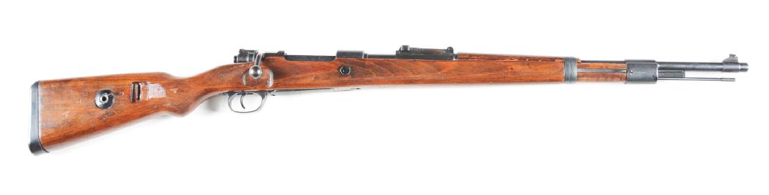 (C) Late Nazi Marked Steyr-Daimer-Puch K98 Bolt Action: Late Steyr-Daimer-Puch receiver dated 1945. Russian capture mark of left side of receiver. Matching numbers include: receiver, barrel, and stock. Faux Waffenamt stampings on right side of rear stock. 