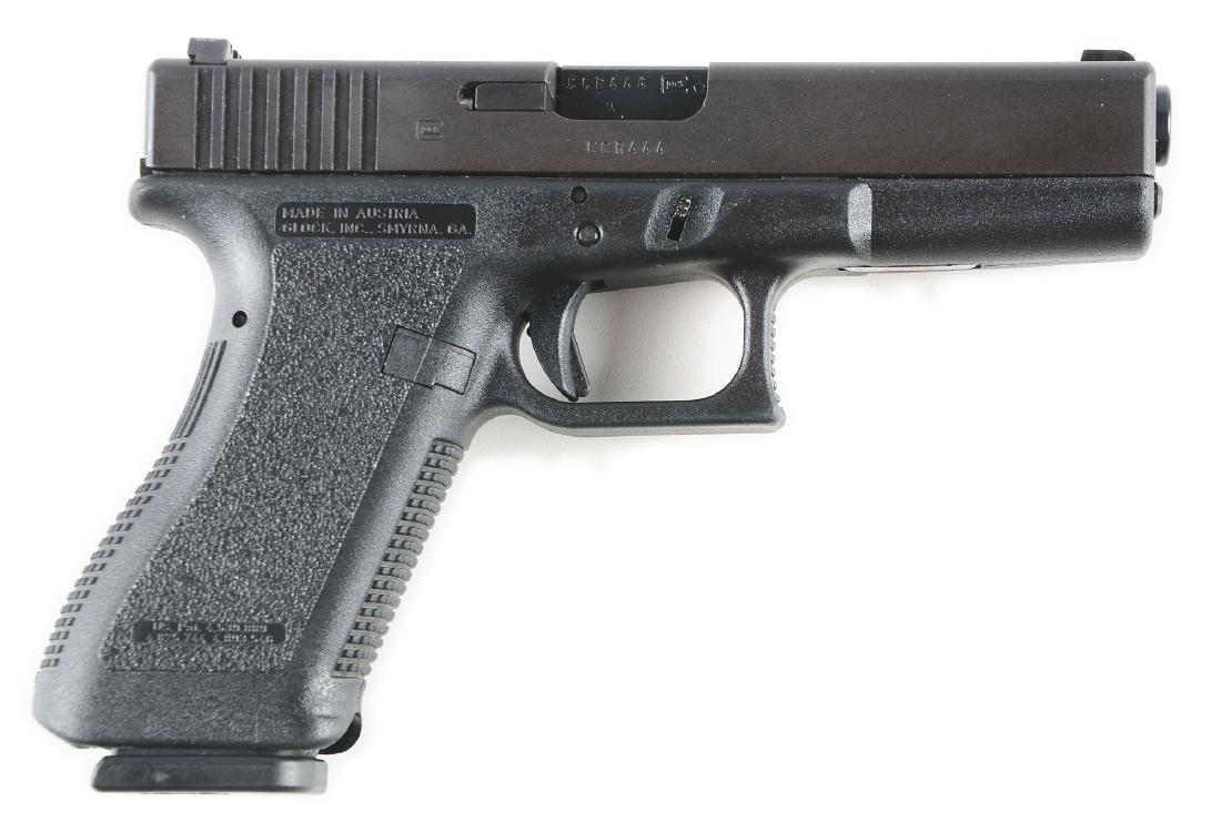 (M) Cased Glock Model 22 Semi-Automatic Pistol with: Features polymer frame, matte finish, steel slide, white dot sights. CONDITION: Like new in original case with three magazines. Accessories: case, 2 extra mags, holster Barrel Length: 4 - 1/2" Caliber