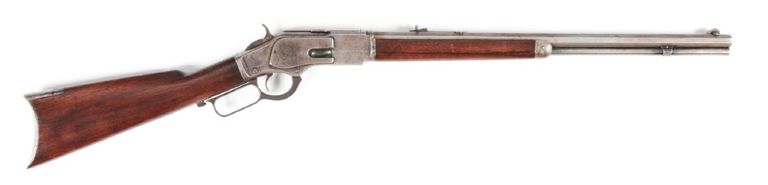 (A) Winchester Model 1873 Lever Action Rifle.: Made in 1891. Winchester 3rd Model 1873 lever action rifle with octagon barrel and full magazine. Blade front sight with elevated rear sight. Blued action with serrated dust cover. Brass elevator with