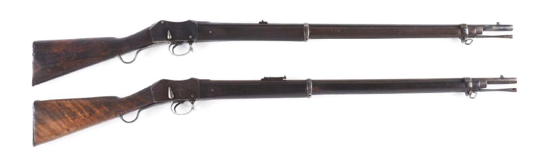 (A) Lot of 2: Martini-Henry British Military Issue: Lot consists of: Two rifles struck with the crown over "VR". Gun (A) 1877 dated with original ramrod and sling swivels. CONDITION: Retains considerable original arsenal bluing. Stock has been cleaned 