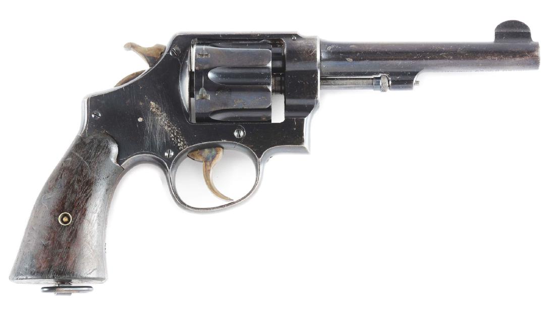 (C) Smith & Wesson US Model 1917 Double Action: US Military issue Smith & Wesson Model 1917 Double Action Revolver. Standard features include six shot fluted cylinder, blue finish, two piece walnut grips, and lanyard ring. Case colored hammer and t