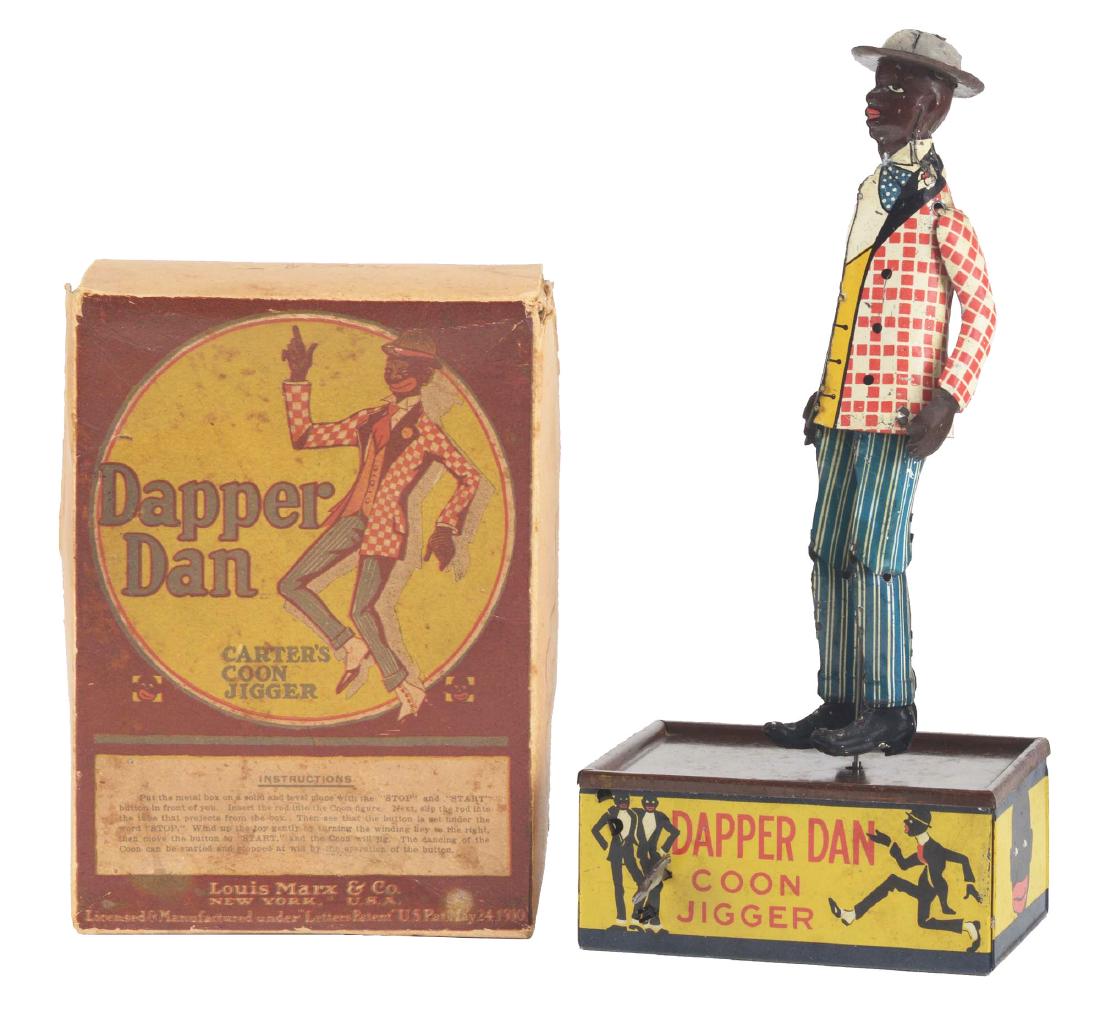 Marx Tin Litho Wind Up Dapper Dan Roof Dancing Toy In: Includes original box, marked "Dapper Dan Carter's Coon Jigger". Nice lithography on front of box. Toy depicts African American dancing on a box. Nice lithography around base of toy. All original incl