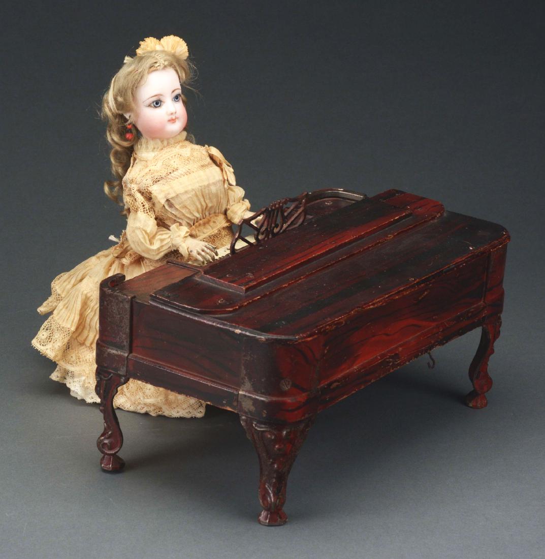 Secor Lady at the Piano.: Overall in very fine, original condition. This particular example has a French bisque fashion head, in working order. Dress, if not original, is certainly of the period. Condition: Dimensions: 10 -1/2