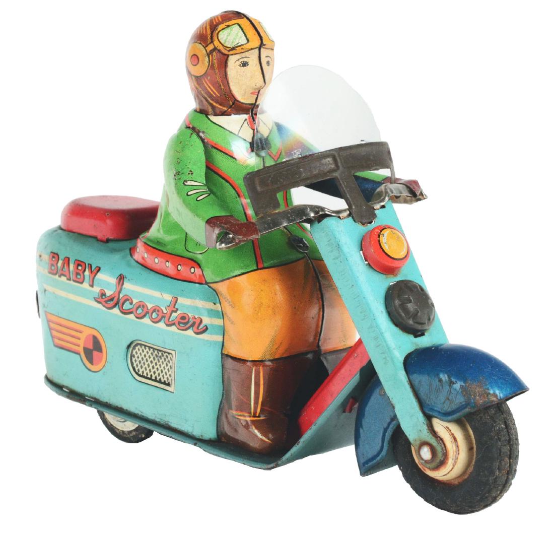 Tin Litho Friction Baby Scooter.: Japan, unknown maker. Works with friction drive, some crazing throughout and a small area of oxidation on the front fender, windscreen replaced. Toy is very good to excellent, 7".Condition: Dimensions