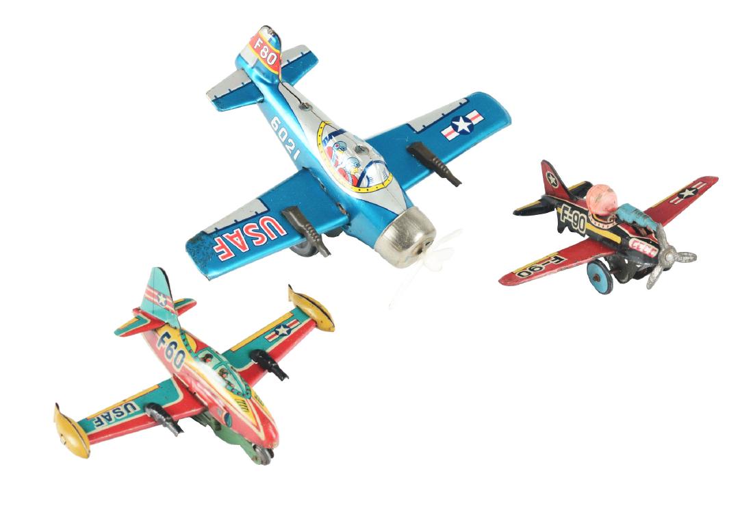 Lot of 3: Tin Litho Friction Planes.: The first is a USAF F-60 fighter jet, Japan. Working, but friction sticks, excellent, 5-1/2" wingspan. The second is a F-90 plane with machine gun, Japan, Bandia. Works, needs flint, celluloid head ha