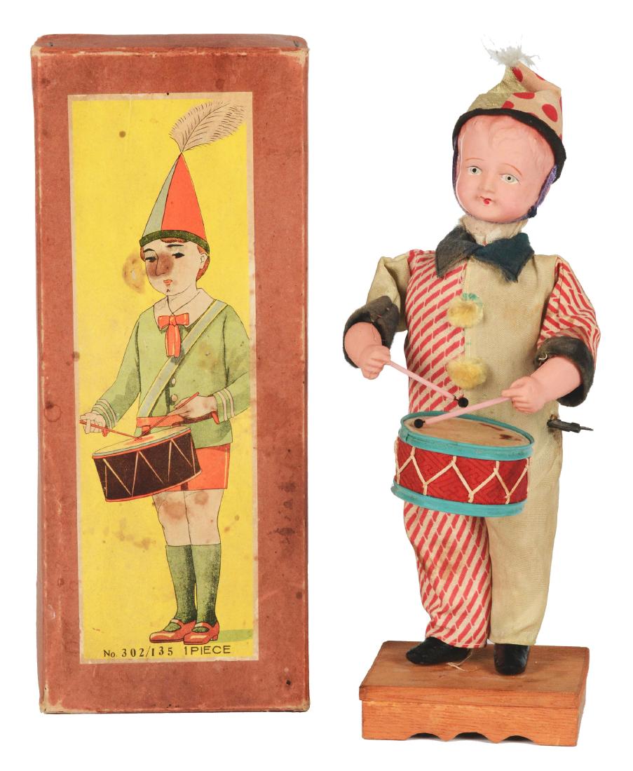 Large Celluloid Pre-War Japanese Wind Up Drumming: Pre-war Japan. Scarce variation of this large toy. When wound, the clown plays drum as his head moves back and forth, working, 11-1/2". Includes original box with original tissue, some staining on lab