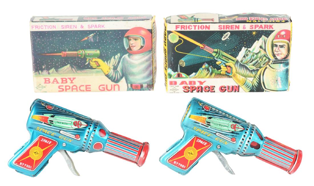 Lot of 2: Tin Litho Baby Space Guns.: The first is a Baby Space Gun, Japan, Daiya. Works but slips, no spark, excellent, 6". Includes original box, near mint. The second is a working with a good spark, near mint, 6". Includes original box