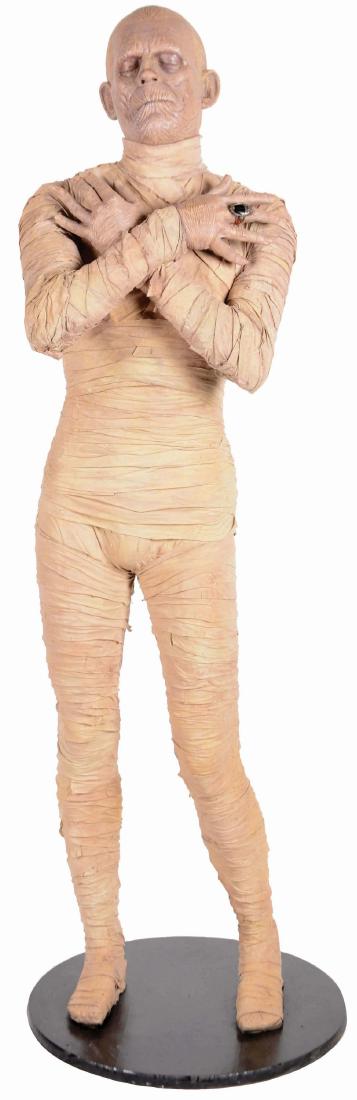 Boris Karloff Mummy Universal Monster Statue.: This life size, iconic figure of 1930's Hollywood horror has been expertly sculpted, molded from foam, airbrushed, and wrapped in stiff bandages. Mounted on a 24" circular wood base. A black scarab ri