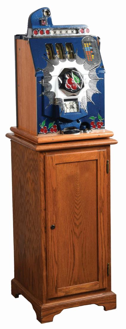 **5¢ Mills Novelty Co. Bursting Cherry Slot Machine: A restored slot machine of Mills Novelty Co. manufactured in 1937, featuring the bursting cherry front. There is polished nickel plating throughout with details of red, white and blue. This machine is