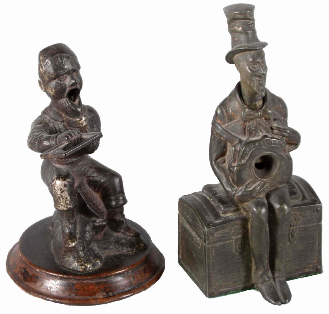 Lot Of 2: Cigar Cutters.: Lot consists of 1- cast iron cigar cutter of the iconic dunce boy with great patina and in super original working condition, resting upon a wood base. The manufactures inscription on the base is illeg