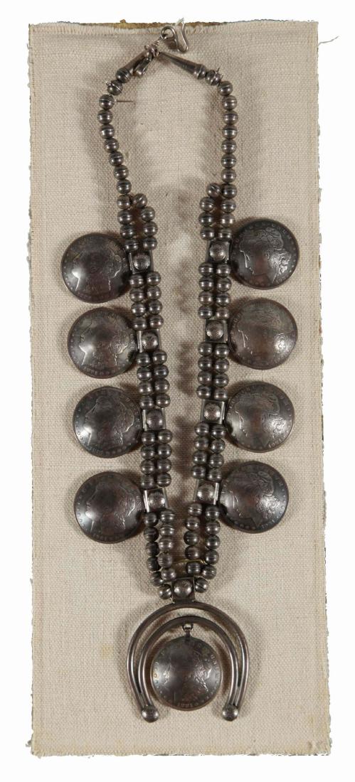 Antique Navajo Morgan Silver Dollar Necklace.: Circa 1920's Navajo Morgan silver dollar squash blossom. This piece features a center dollar pendant with a silver naja surrounding it. The necklace shows very nice Morgan Silver Dollar blossoms. The 