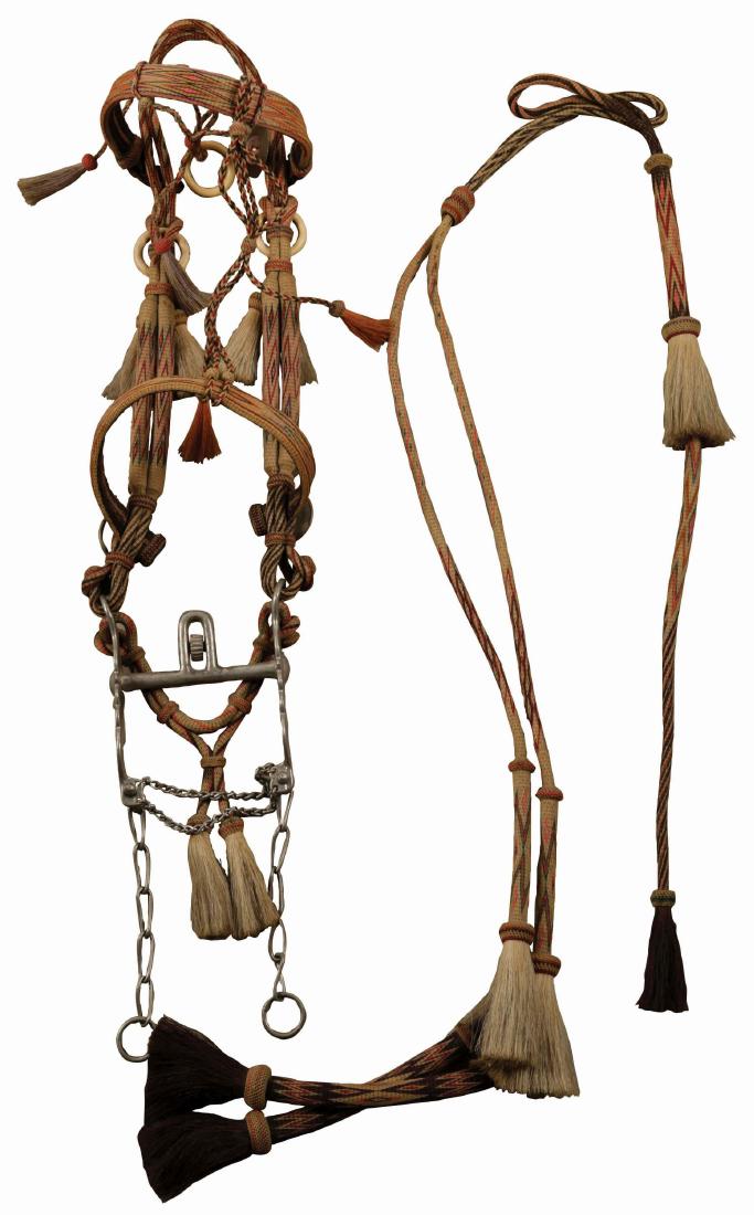 Antique Deer Lodge Bridle.: Circa 1920's, polychrome in red, pink, black, orange, and green with rounded headbands, flat cheeks. Split reins, natural and dyed orange horse hair tassels, horse and elk pictorial rosettes with peri