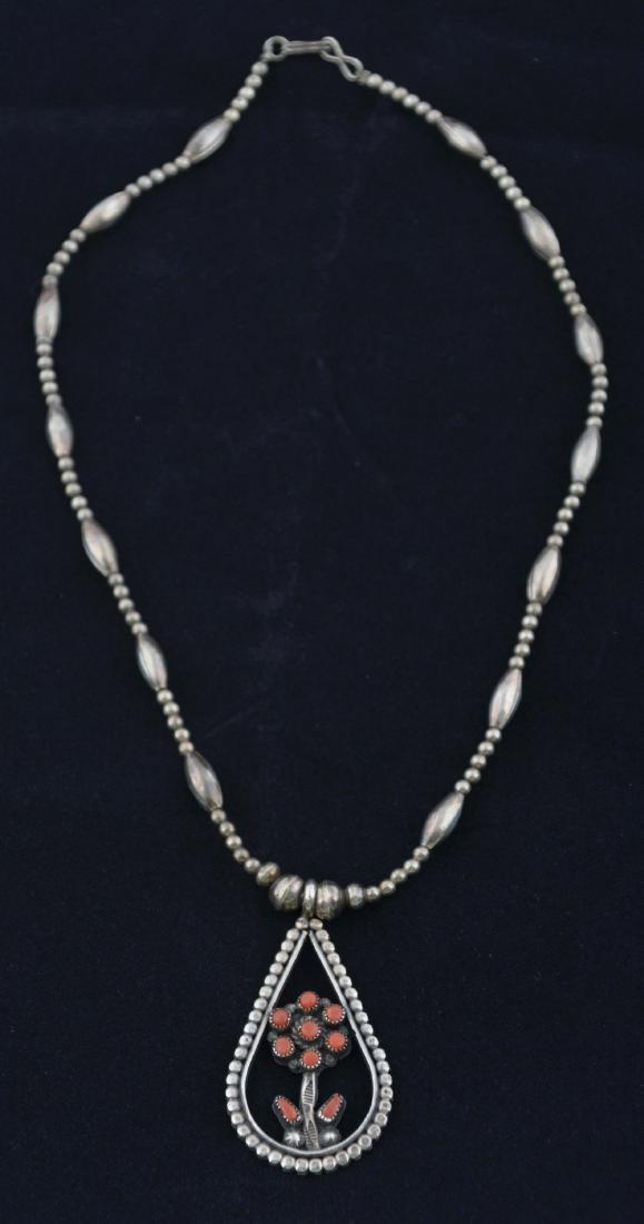 Silver Necklace With Coral Blossom.: This 18" long, silver beaded necklace is adorned with a drop shaped amulet with a coral adorned flower.Condition: (Very Good - Excellent).Dimensions: 18" Long.
