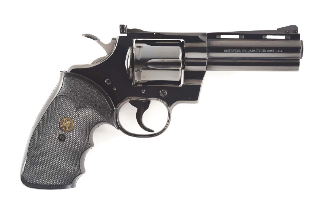 (M) COLT PYTHON DOUBLE ACTION REVOLVER (1981).: Features high polish factory blue finish, vent rib, solid lug, target adjustable rear sight, wide target hammer, six shot, fluted cylinder, and Pachmayr hard rubber grips. CONDITION: Aside from an alm