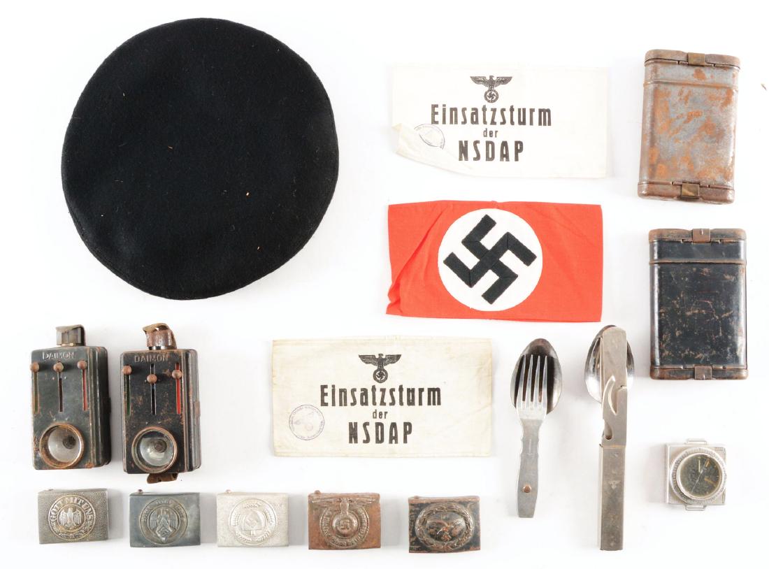 LOT OF 15: THIRD REICH ARMBANDS, BUCKLES, AND FIELD: Lot contains: (A) Three Nazi Party armbands, (B) Five Third reich belt buckles, (C) Two k98k cleaning kits, (D) Two sets of Wehrmacht eating utensils, and (E) Finnish compass. (F) Two Wehrmacht flashl