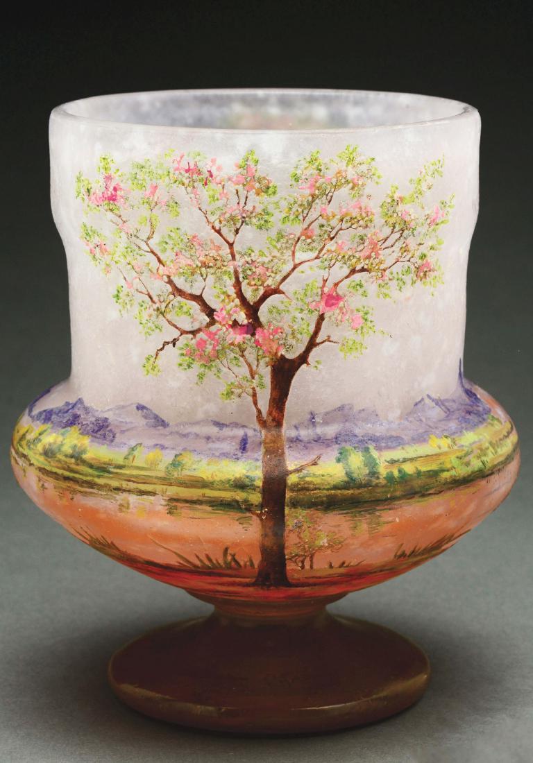 Daum Nancy Scenic Vase.: Daum cameo and enameled vase has a central tree on the front and back of vase with enameled landscape encircling the vase. The tree bark is enameled in shades of brown and the foliage and flowers of t