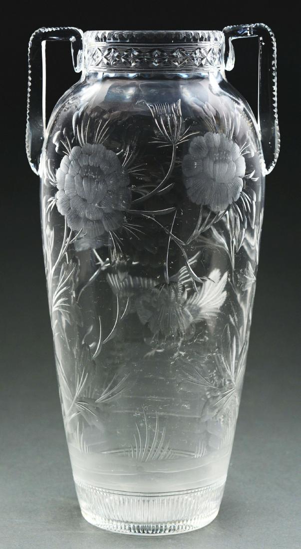 Intaglio Carved Vase.: Clear crystal vase is intaglio carved on the front with two birds and a large flower. The floral design extends around to the back, with two more large flowers along with stems and leaves. The vase is