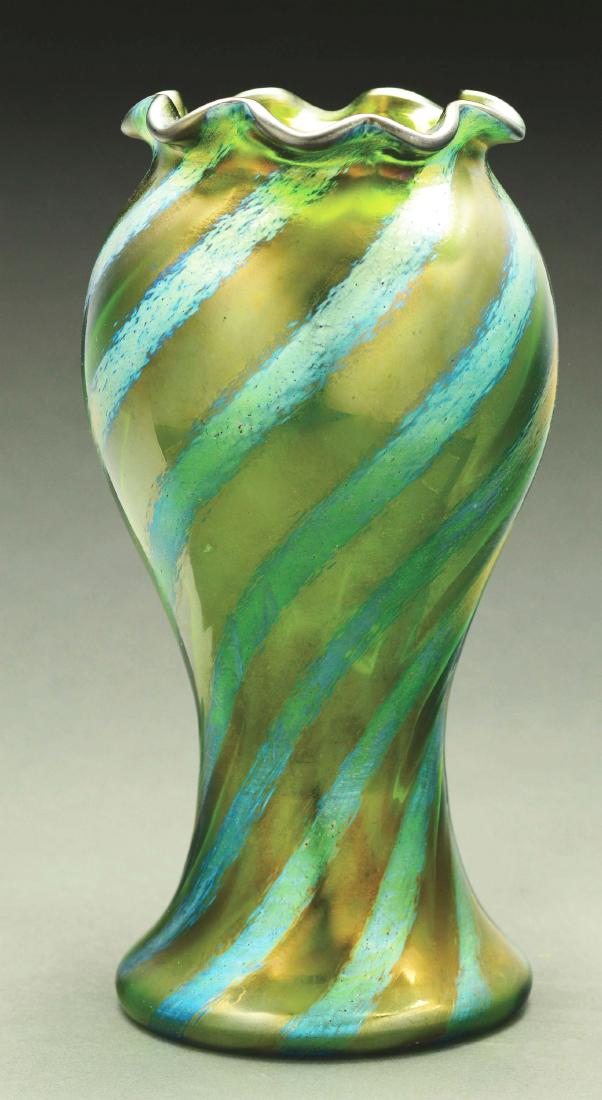 Loetz Spiral Silberiris Vase.: Loetz vase is executed with Crete ground having spiral bands of Silberiris rising diagonally up the body to the ruffled rim. Unsigned. Very Good to Excellent. Condition: Dimensions: 8 - 3/4" x 4 - 1/2