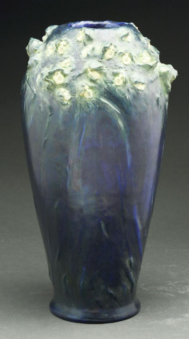 Large Amphora Vase with 100 Faces.: Vase has beautiful deep blue colors, decorated with female faces encircling the mouth. Marked "AMPHORA". Condition: (Excellent). Dimensions: 17" x 5" x 5 -1/2".