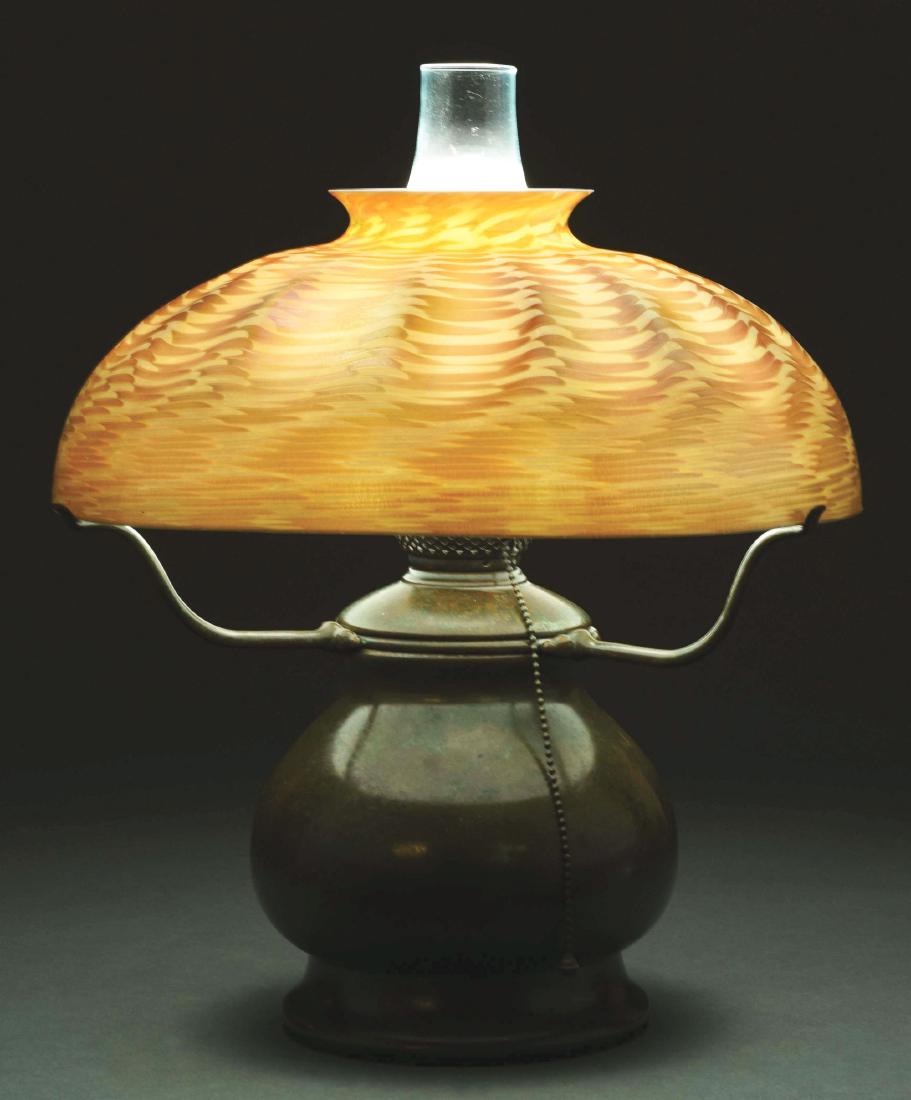 Tiffany Studios Damascene Table Lamp.: Tiffany Studios table lamp has a large gold Damascene shade. The Damascene design is set against a cream colored background and the gold iridescence shows nice flashes of pink. Signed on the interior 