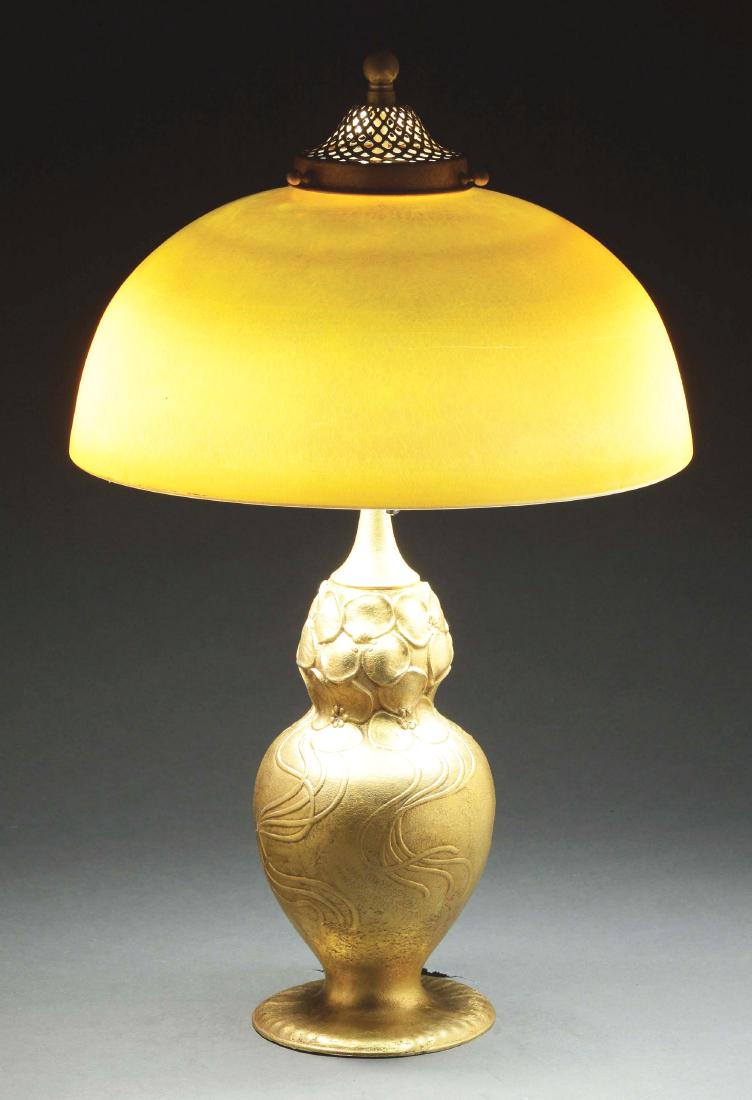 Tiffany Studios Table Lamp.: Tiffany Studios table lamp has large dome gold Favrile shade with nice flashes of pink and green. Signed in the fitter "L. C. TIFFANY FAVRILE". The shade rests on a Tiffany Studios bronze base with ca