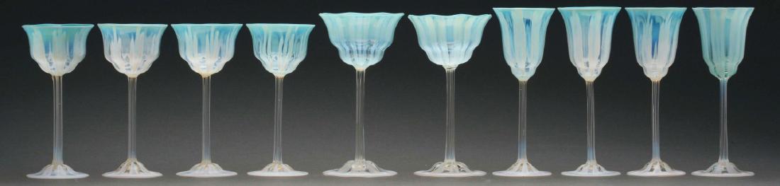 Lot of 10: Tiffany Favrile Pastel Stems.: Lot consists of ten Tiffany Favrile pastel stems including four wine glasses, four sherbets, and two champagnes. Each has a clear stem with white opalescent bands on the foot and pastel aqua cups with
