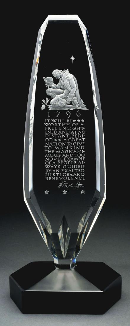 Steuben Washington Sculpture with Display Box.: Steuben clear crystal sculpture has intaglio carved and frosted depiction of George Washington in uniform, kneeling with hat and Bible in hands, underneath is a carved 1796, below the date is a passag