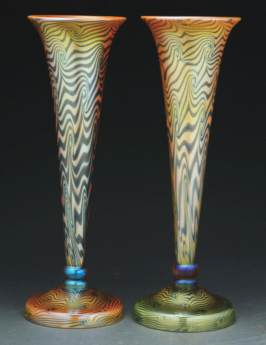 Two Durand King Tut Trumpet Vases.: Two Durand trumpet vases have green iridescent King Tut design against a gold iridescent background. One vase has a green iridescent King Tut pattern foot, while the other has a gold iridescent King T