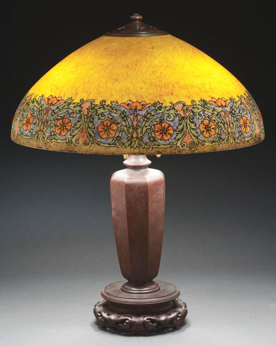 Handel #6778 Table Lamp.: Handel lamp has obverse painted band of stylized orange flowers with scrolling stylized green leaves all set against an amber colored background with chipped ice finish. Shade is signed on the interio