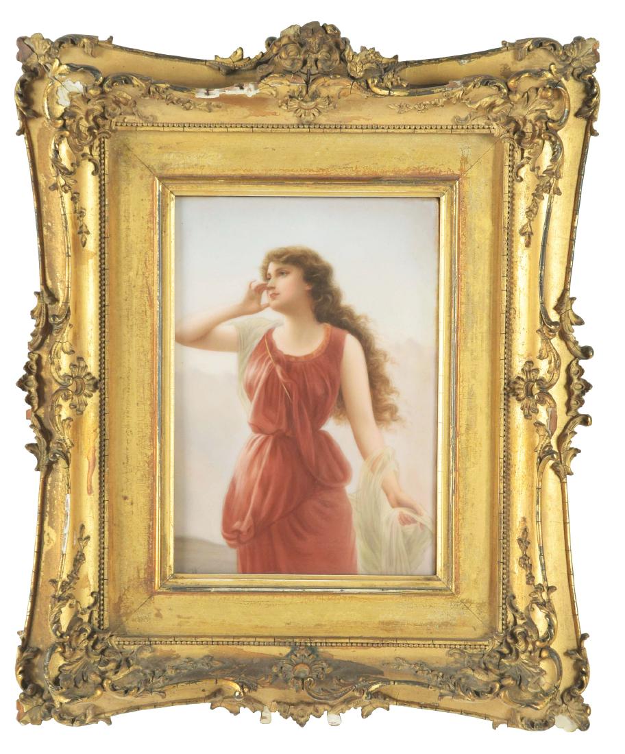 Porcelain Plaque of a Woman in a Red Dress.: Late 19th century. Austria. Signed "WAGNER" lower-left corner. The young woman with brown hair and white, diaphonous shawl, her right arm raised. Housed in a molded giltwood frame. Condition is very g