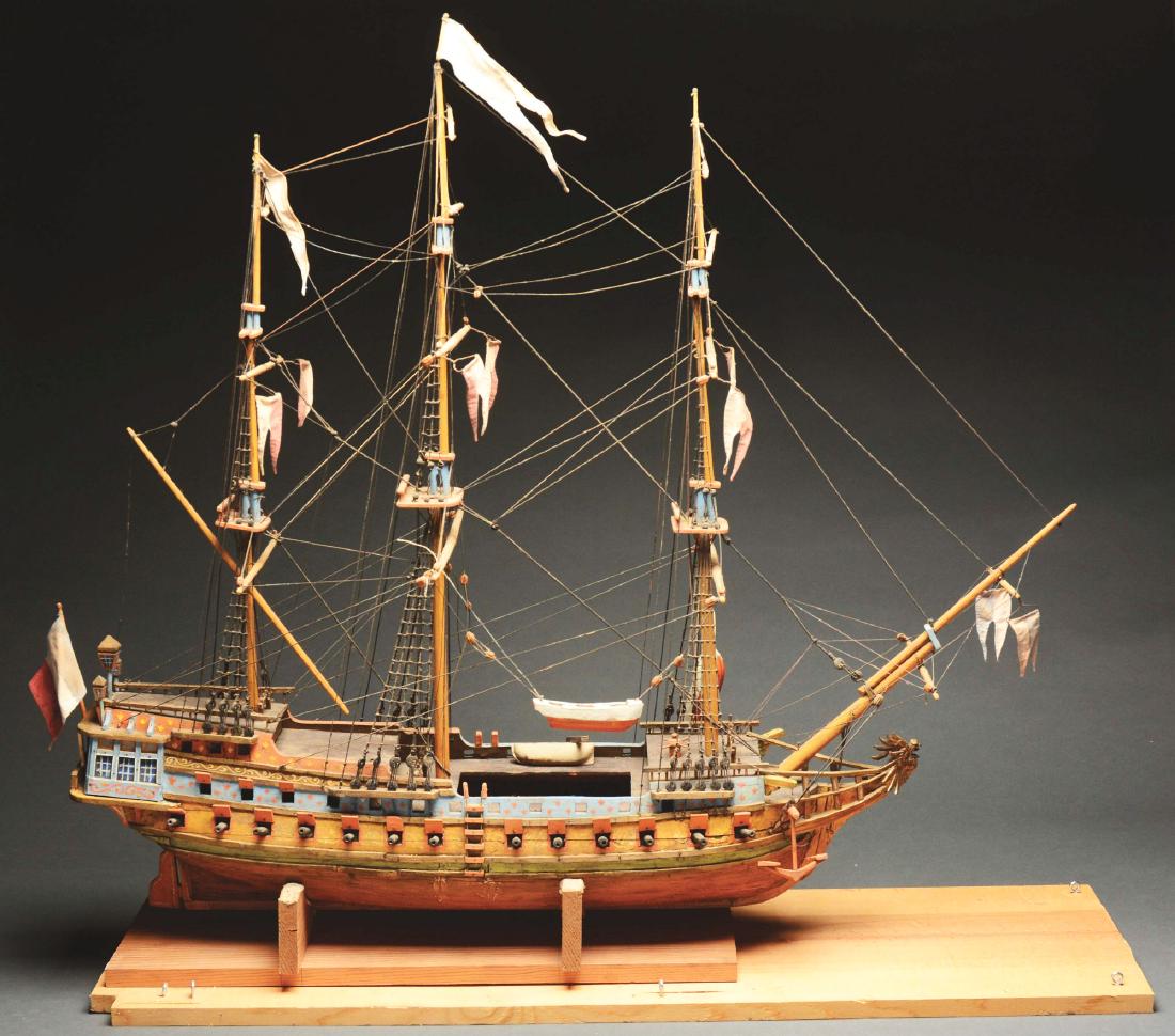 Wooden Ship Model.: Three-masted wooden ship with cannons. Flags loose but riggings intact - good condition overall.Paperwork: Condition: Dimensions: 40" x 36" x 11".
