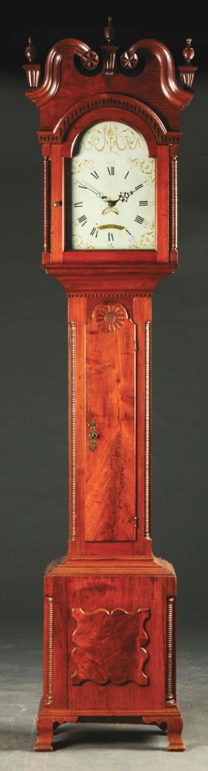 Fine Benjamin Morris Chippendale Walnut Tall Case: Last quarter 18th century. New Jersey/Pennsylvania. Fine clock features a bonnet with a dramatic molded swan's neck pediment with carved star rosettes, alternating with three urn-form finials on corbe