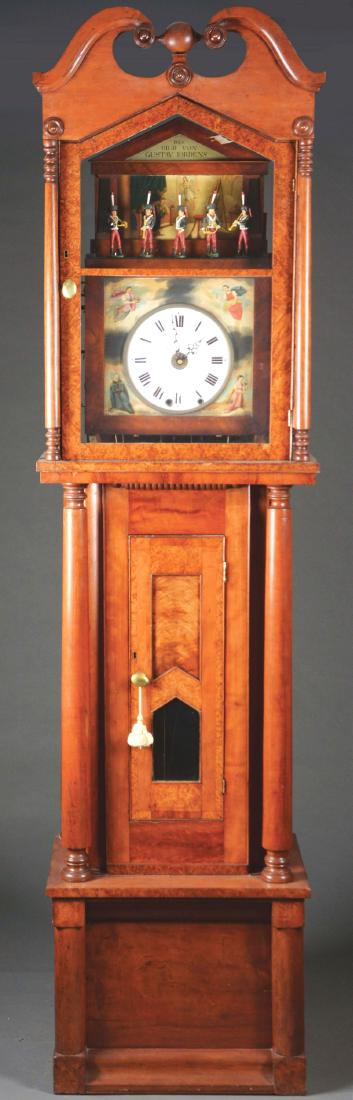 Fine Automaton Musical Tall Case Clock.: This fine and important tall case clock features a bonnet with arched swan's neck molded crest, centering a ball finial above the frieze, with turned rosettes at the corners above the Gothic style poi