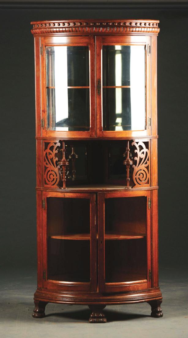 Aesthetic Movement Oak Corner Bowfront China Cabinet.: Late 19th century. American. China cabinet features a quarter-sawn case with molded cornice above a pair of bowed beveled glass paneled doors. The mirrored interior is fitted with an oak shelf above a