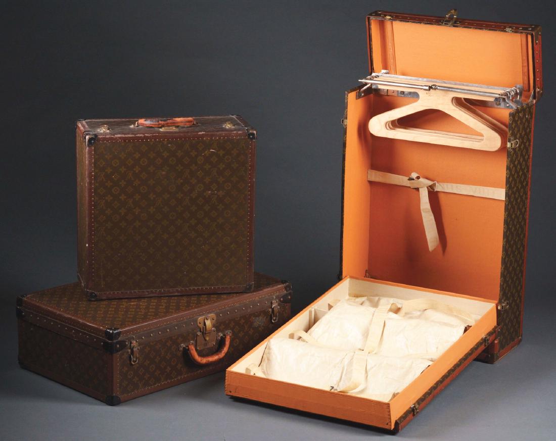 Lot of 3: Louis Vuitton Travel Set.: Early 20th century. France. The three pieces comprise a wardrobe suitcase, a small overnight case, and a suitcase of standard shape and form. All three leather bound with brass rivets and corners. All