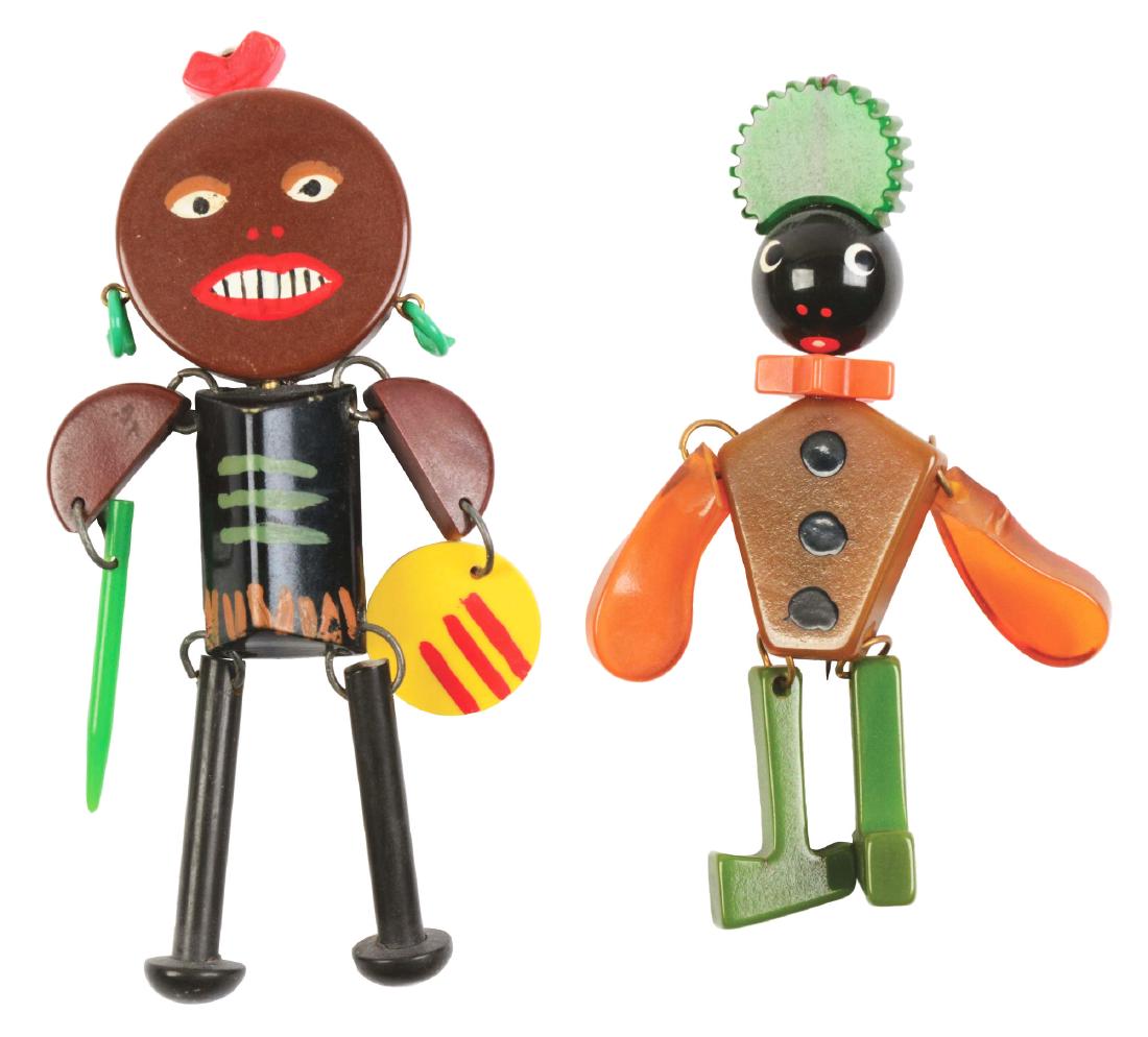 Lot of 2: Figural Bakelite Pins.: Rare pair of figural pins. A native and a butler. Great detail and color. Condition: (Excellent). Dimensions: Largest: 4 - 1/2" x 2".