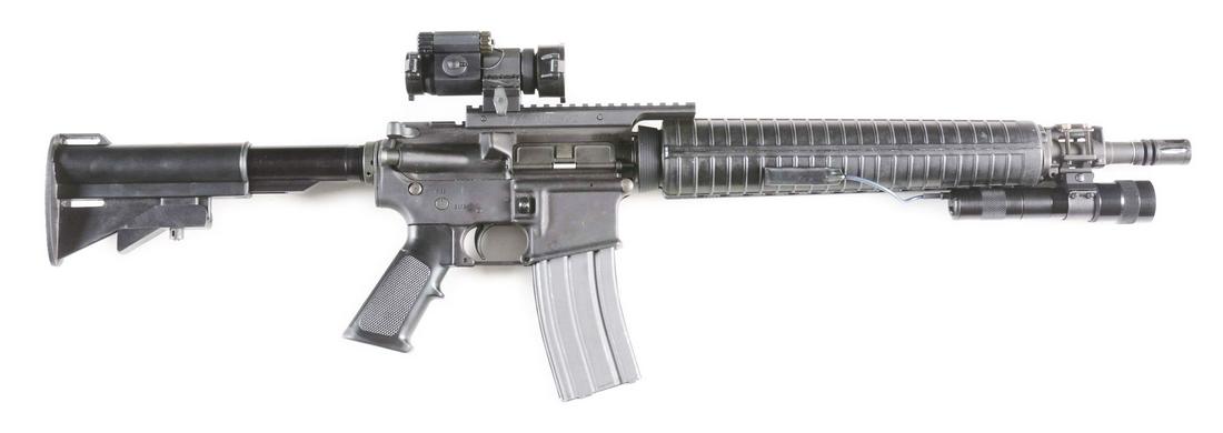 (M) BUSHMASTER XM15-E2S SEMI-AUTOMATIC RIFLE WITH: Bushmaster lower, unmarked upper. GGG added section of rail and scope mount, holding an Aimpoint Comp M. Telescoping stock, A2 style grip and handguard. Added section of rail forward of handguard for 