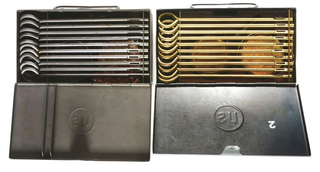 PAIR OF WORLD WAR I & WORLD WAR II COLT MODEL 1911: These are government issue so called squad cleaning kits made for the Model 1911. Each metal carry case is embossed with US logo on top. The early set dating to World War I has ten brass rods, oiler,