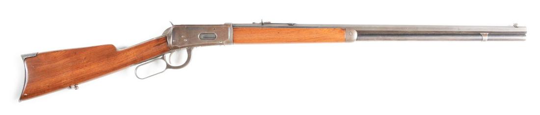 (C) WINCHESTER MODEL 1894 LEVER ACTION RIFLE (1906).: Winchester Model 1894 made in 1906 with full blued octagon barrel and magazine tube. Rifle sights. Blued receiver and walnut stocks with crescent steel butt plate. CONDITION: Overall blue fading to br